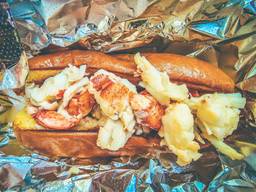 A loaded lobster roll in foil