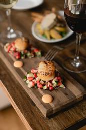 Seared scallops with strawberry salsa and two wine glasses