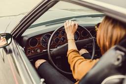 Hands on the steering wheel of a vintage Mercedes